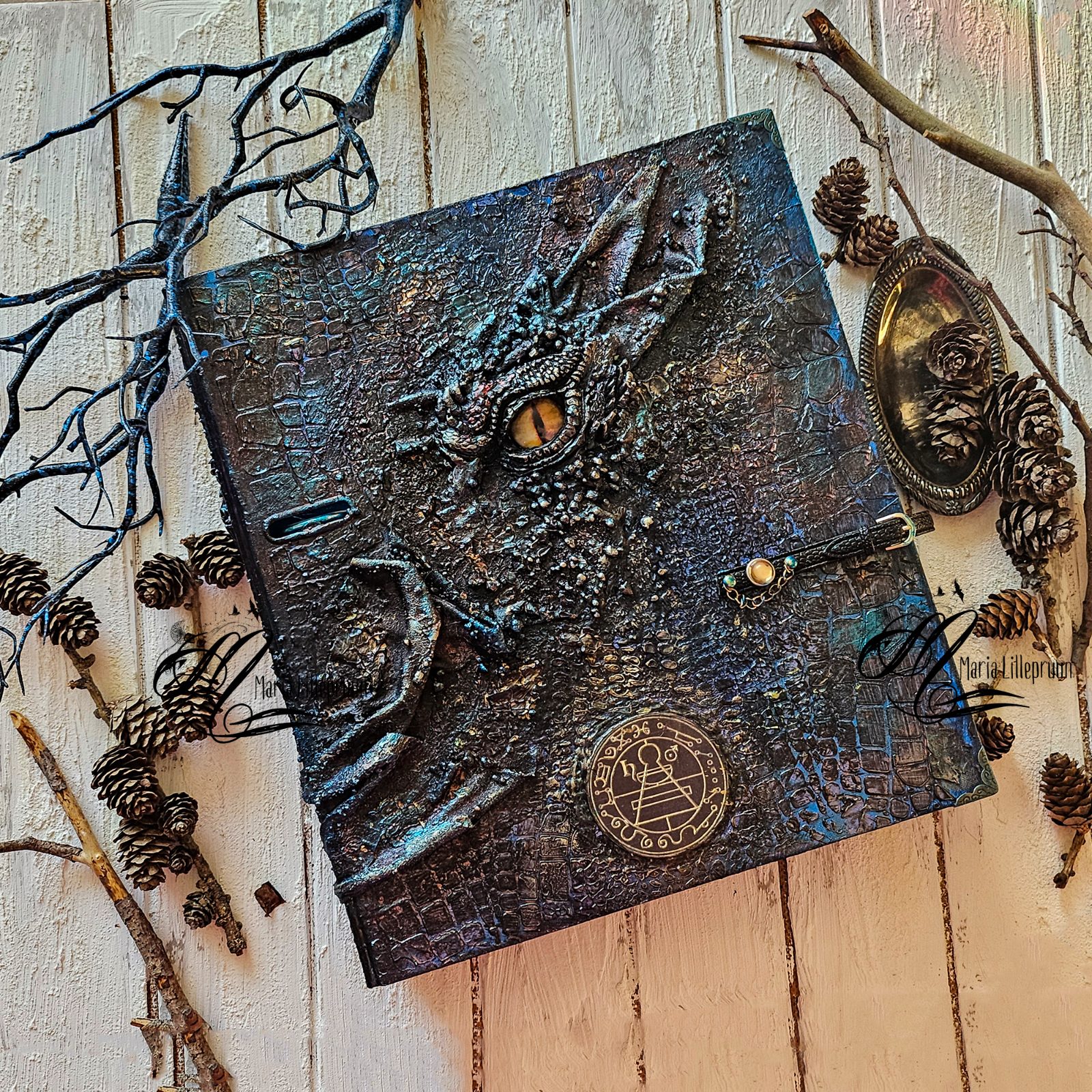 Album with a decorated mixed media cover featuring a dragon eye