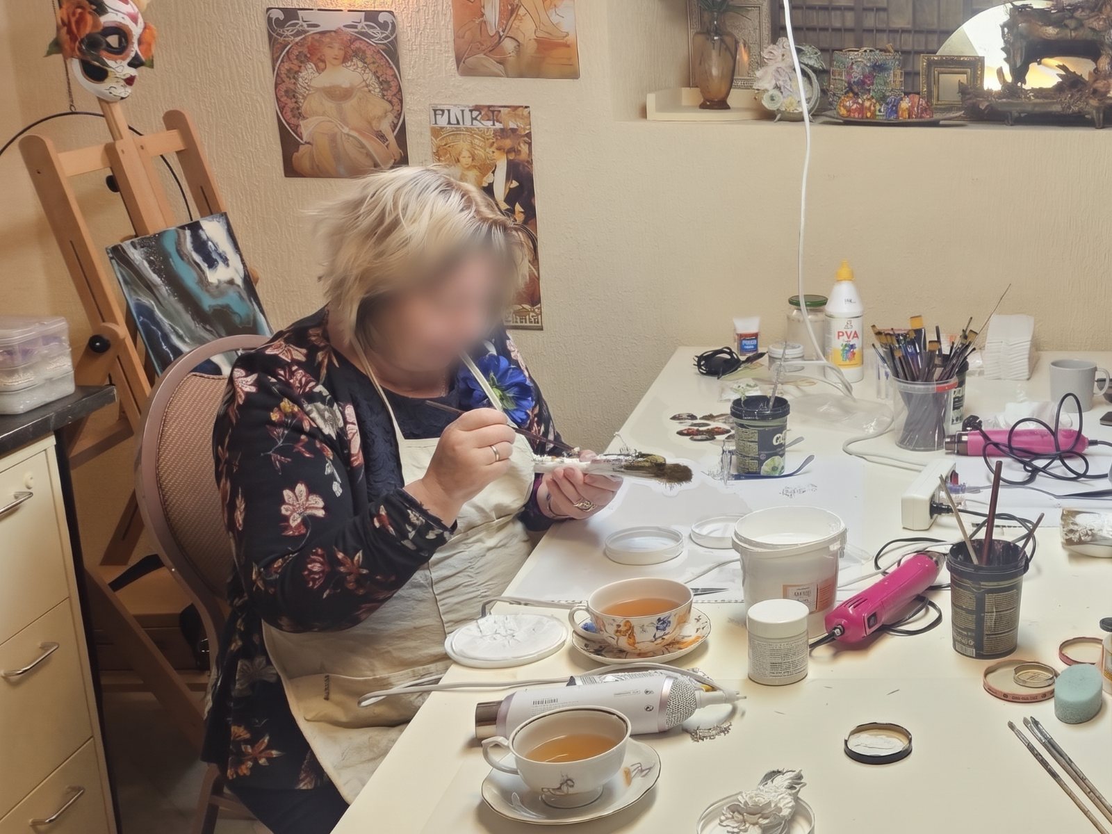 Participant painting at a private mixed media workshop in a cosy studio