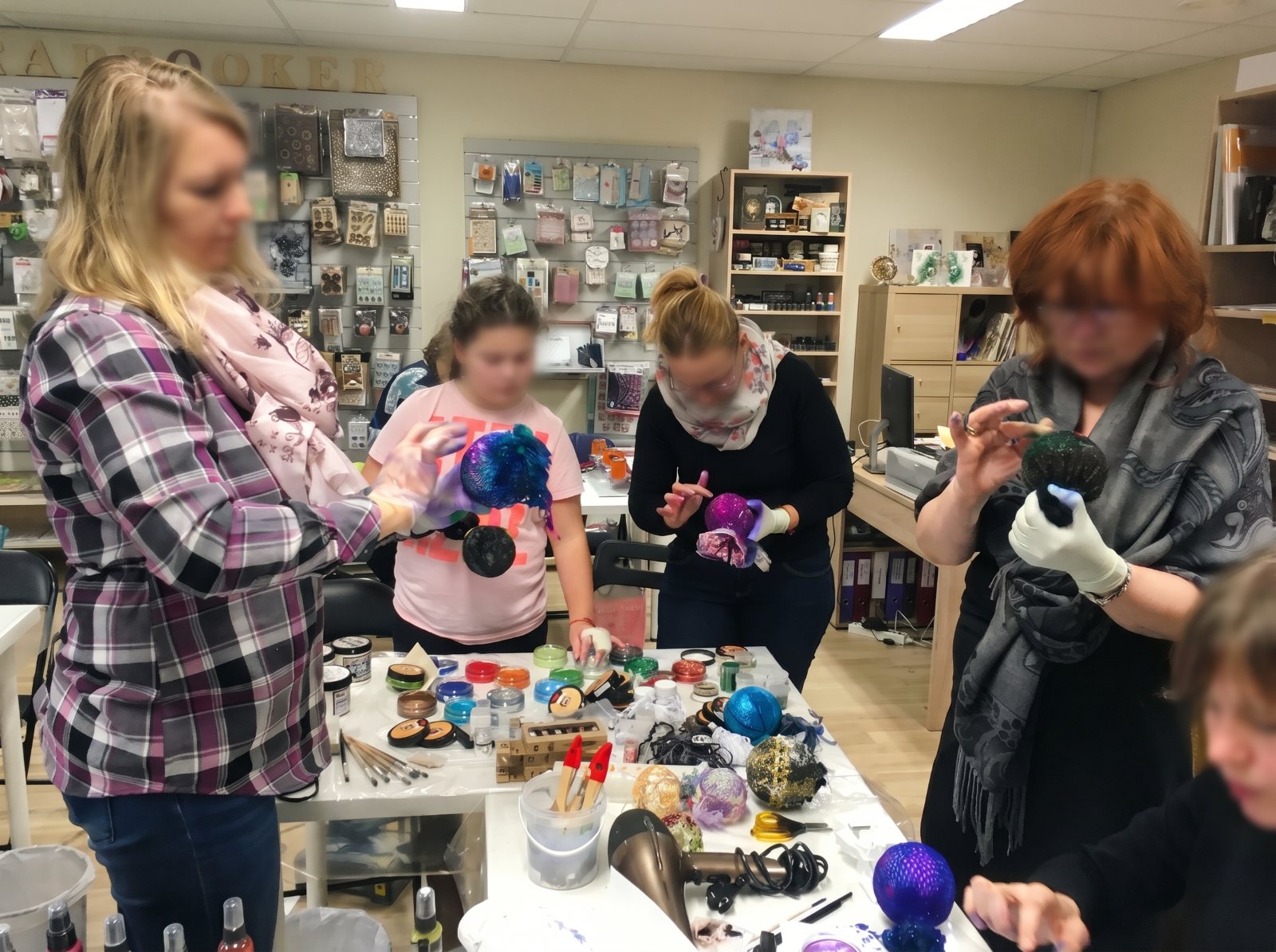 Small group of women decorating ornaments at a mixed media workshop